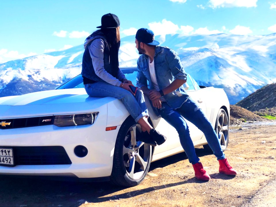 Couple Near White Chevrolet Coupe