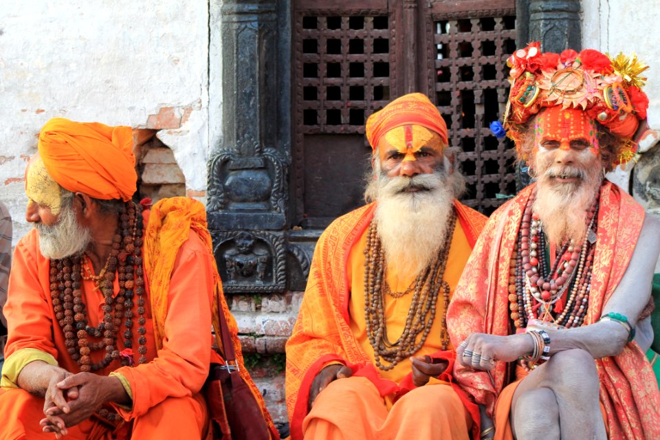 Three Men Wearing Orange Tradition Clothes