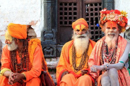 Three Men Wearing Orange Tradition Clothes photo