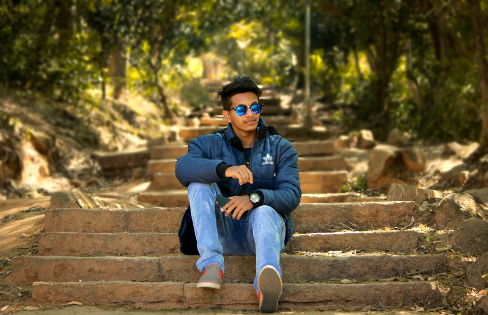Man Wearing Blue Jacket Sitting Stairs