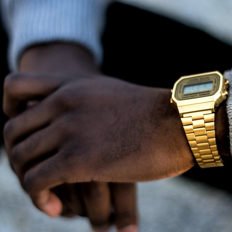 Person Wearing Gold-colored Casio Digital Watch With Linked Strap