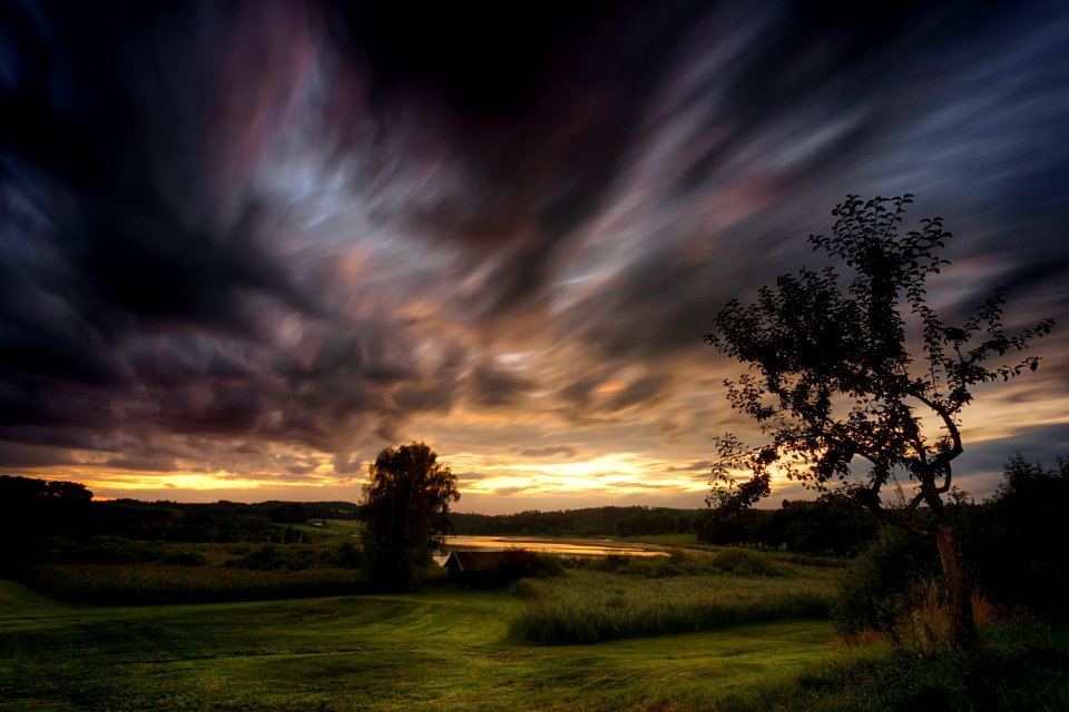 Green Grass Field With Dark Sky