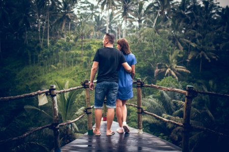 Man And Woman Standing On Hanging Bridge photo