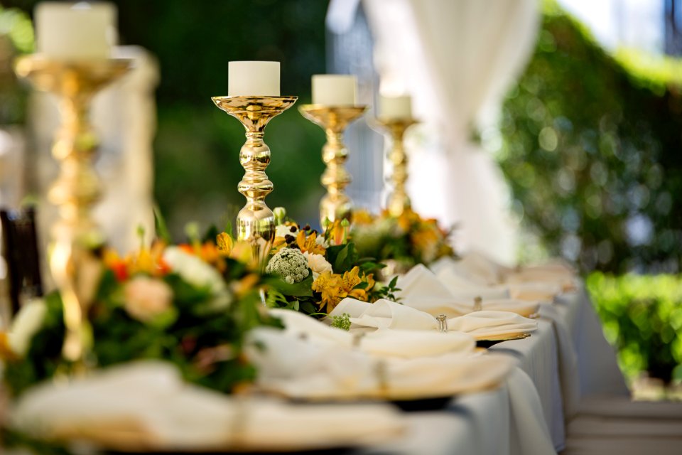 Four White Tealight Candles On Brass-colored Candlesticks
