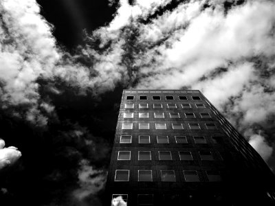 Low-angle Photography Of Concrete High-rise Building Under Cloudy Skies photo