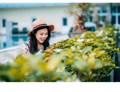 Woman Wearing Brown Hat Standing Near Plants photo