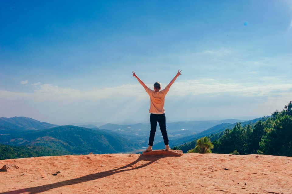 Woman Standing On Cliff