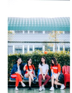 Four Girls Sitting In Gray Steel Bench photo