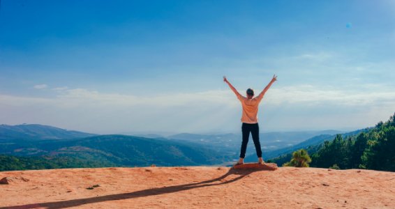 Person In Beige Top On Mountain Cliff photo