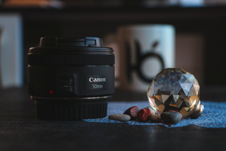 Close-Up Photography Of Camera Lens Near Gem
