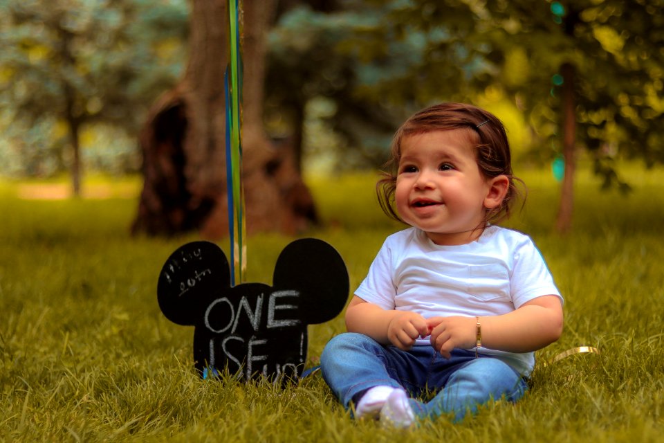 Baby Sitting On Lawn Grass