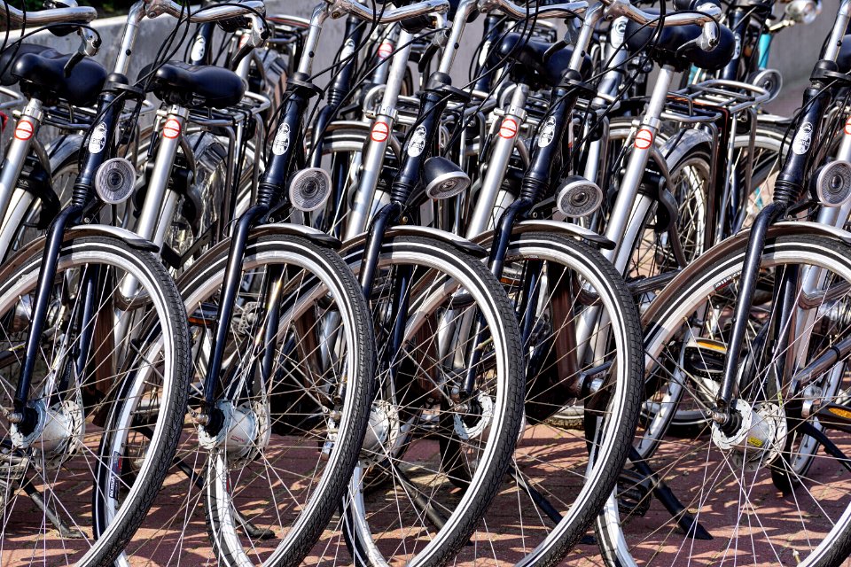 Gray And Black Bicycles Parked Near Gray Wall photo