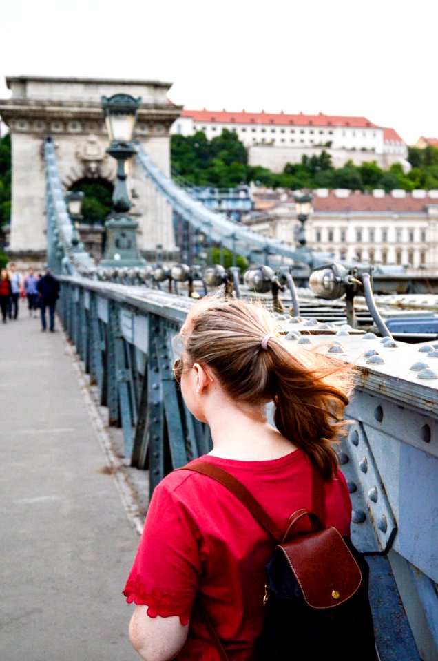 Woman Wearing Brown Leather Backpack Standing On Bridge Photo Taken