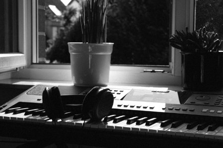 Grayscale Photography Of Electronic Keyboard Near Window photo