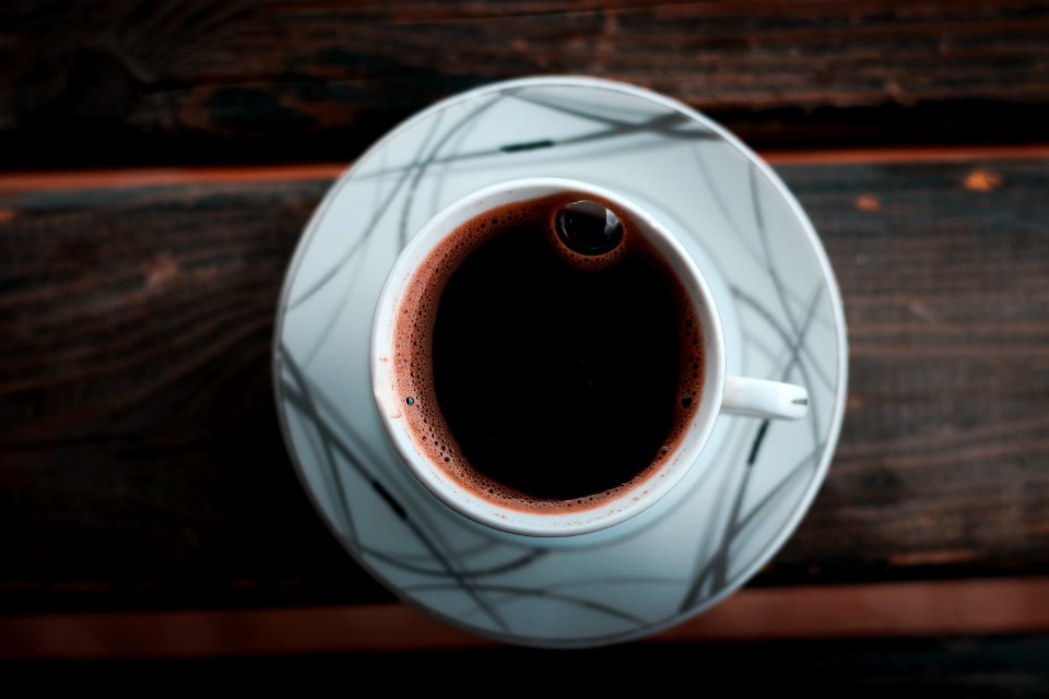 White Cup On Saucer On Brown Wooden Table