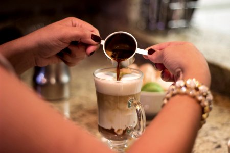 Person Making A Cappuccino Coffee photo