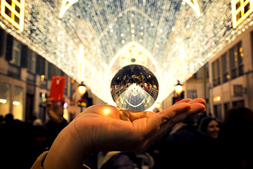 Person Holding Round Silver-colored Accessory