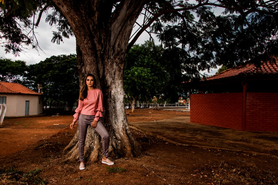 Woman In Pink Long-sleeved Blouse And Grey Pants
