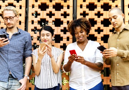Four People Holding Mobile Phones photo