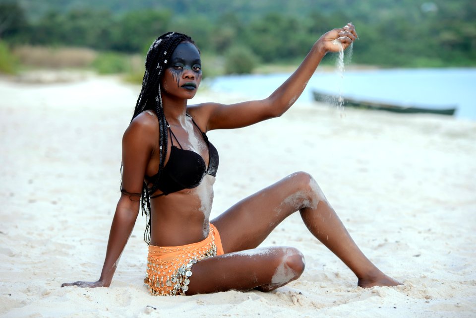 Fashion Photography Of Woman Sitting On White Sand White Pouring Sand On Her Hand