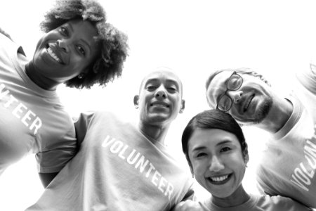 Grayscale Photography Of Group Of People Wearing Volunteer-printed Shirt photo