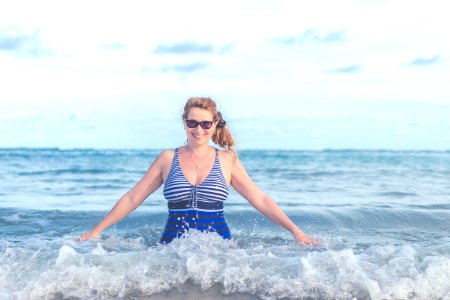 Woman Wearing Blue And Grey Swimsuit On Ocean photo