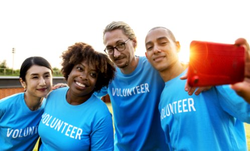 Group Of People Wearing Blue Volunteer Shirts photo