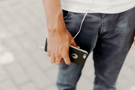 Person Holding Iphone With Black Case