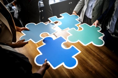 Four People Holding Blue Puzzles