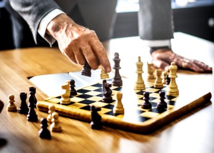Man In Gray Suit Playing Chess photo