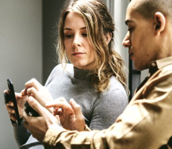 Two People In A Discussion With Mobile Phones photo