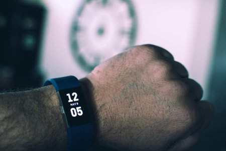 Blue Fitbit Charge Displaying 1205 May 9