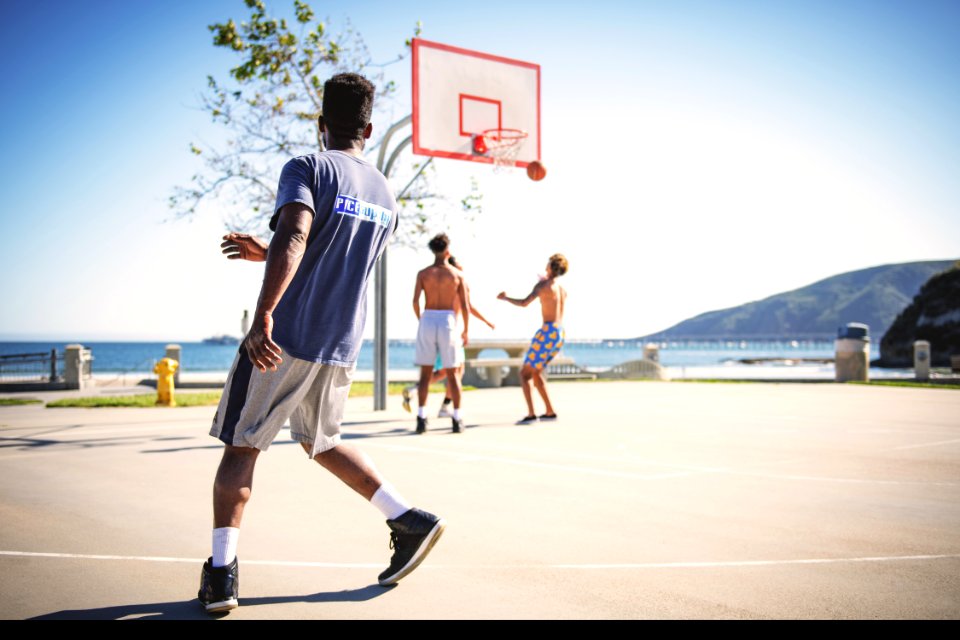 Four People Playing Basketball