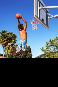 Man Wearing Blue And Yellow Shorts Playing Basketball