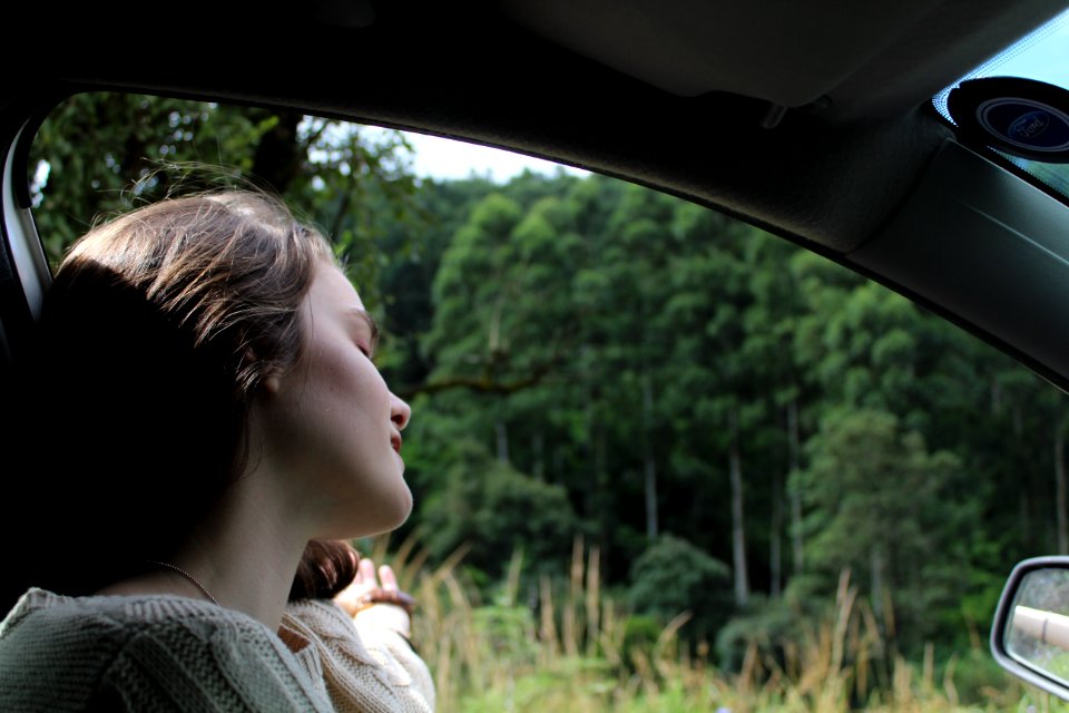 Woman In White Top Inside Vehicle