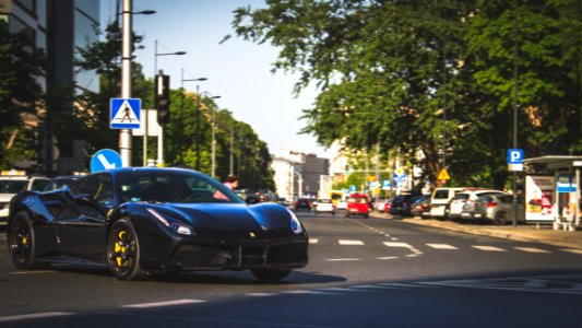 Photography Of Black Ferrari On Roadway photo