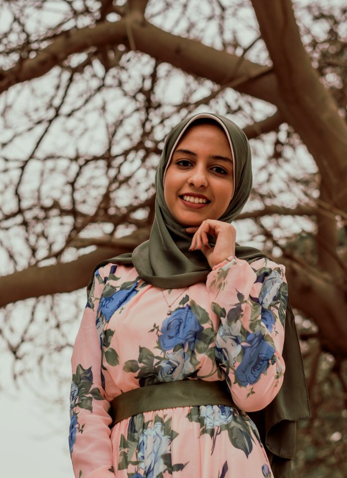 Woman In Floral Abaya Standing Near Tree