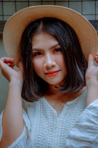 Woman Holding Brown Straw Hat photo