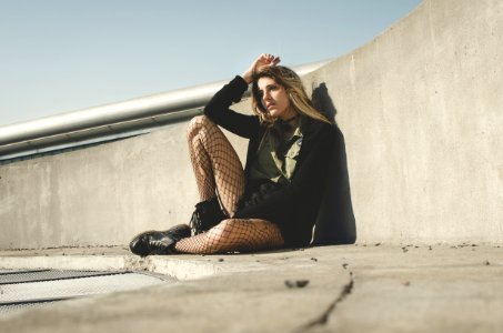 Photography Of A Woman Leaning On A Wall photo