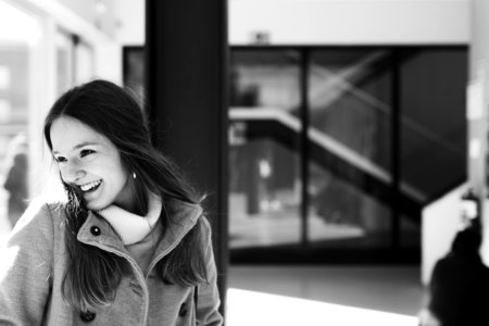 Woman In Gray Jacket Near Black Board