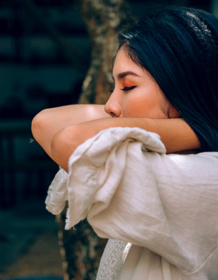 Close-Up Photography Of A Woman Closing Her Eyes photo