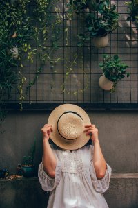 Woman Holding A Brown Hat