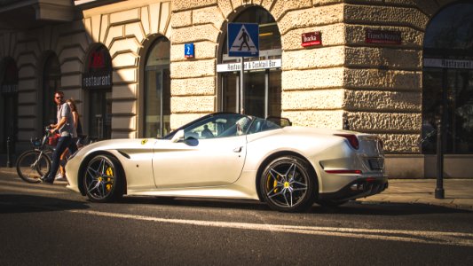 White Coupe Beside Grey Concrete Building photo