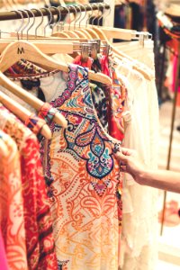 Shallow Focus Photography Of Assorted-color Clothes Hanged On Clothes Rack photo