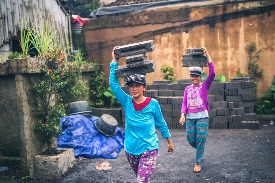 Photography Of Women Carrying Cinder Blocks