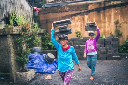 Photography Of Women Carrying Cinder Blocks