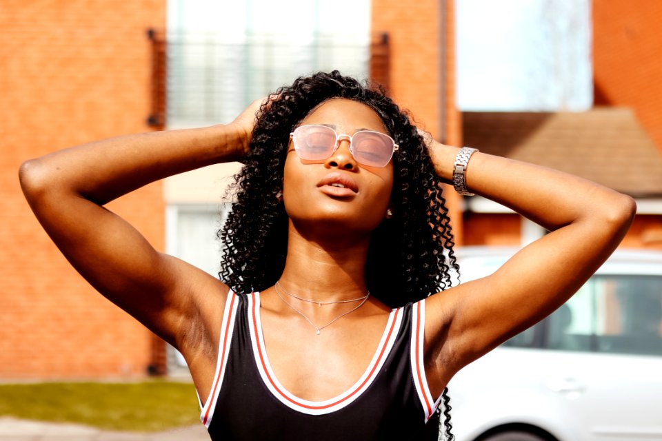 Photography Of Woman In Black Tank Top Holding Her Hair