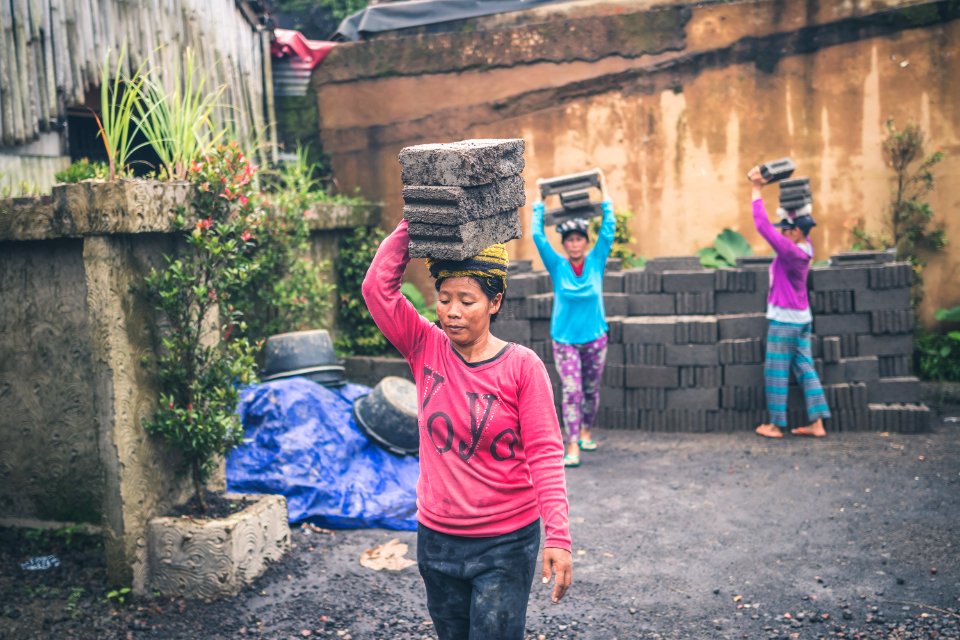 Photography Of People Carrying Cinder Blocks