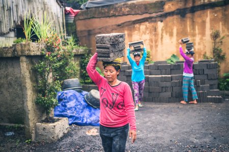 Photography Of People Carrying Cinder Blocks