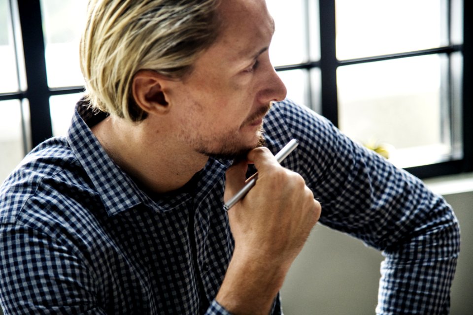 Close-Up Photography Of A Man Holding PPen